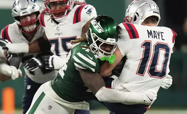 New York Jets linebacker Jamien Sherwood (44) sacks New England Patriots quarterback Drake Maye (10) during the fourth quarter of an NFL football game, Thursday, Sept. 19, 2024, in East Rutherford, N.J. (AP Photo/Seth Wenig)