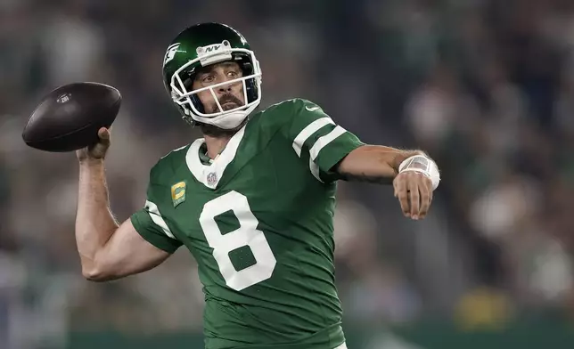 New York Jets quarterback Aaron Rodgers (8) passes against the New England Patriots during the first quarter of an NFL football game, Thursday, Sept. 19, 2024, in East Rutherford, N.J. (AP Photo/Adam Hunger)