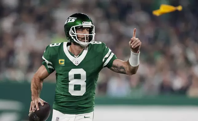 New York Jets quarterback Aaron Rodgers (8) looks to pass against the New England Patriots during the first quarter of an NFL football game, Thursday, Sept. 19, 2024, in East Rutherford, N.J. (AP Photo/Adam Hunger)