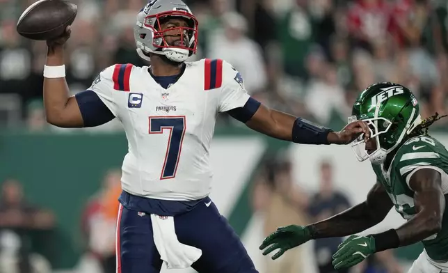 New England Patriots quarterback Jacoby Brissett (7) passes under pressure from the New York Jets during the first quarter of an NFL football game, Thursday, Sept. 19, 2024, in East Rutherford, N.J. (AP Photo/Julia Demaree Nikhinson)