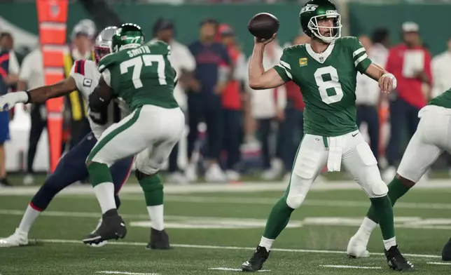 New York Jets quarterback Aaron Rodgers (8) passes against the New England Patriots during the first quarter of an NFL football game, Thursday, Sept. 19, 2024, in East Rutherford, N.J. (AP Photo/Seth Wenig)