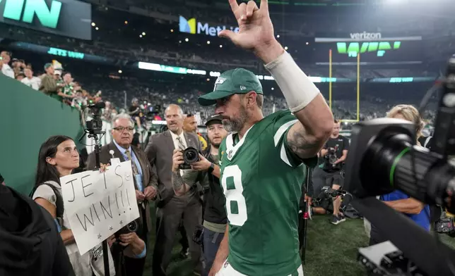 New York Jets quarterback Aaron Rodgers (8) motions to fans as he walks off the field after playing against the New England Patriots in an NFL football game, Thursday, Sept. 19, 2024, in East Rutherford, N.J. (AP Photo/Seth Wenig)