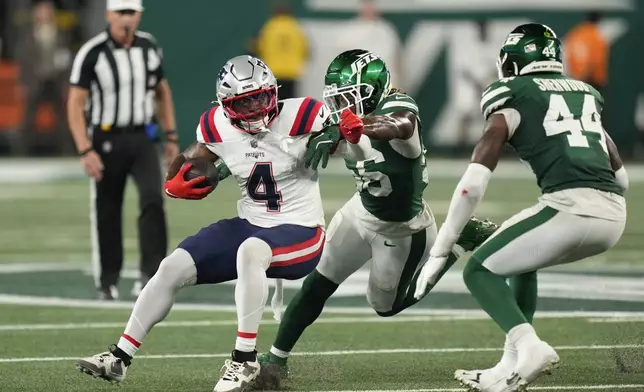 New England Patriots running back Antonio Gibson (4) carries the ball against the New York Jets during the second quarter of an NFL football game, Thursday, Sept. 19, 2024, in East Rutherford, N.J. (AP Photo/Seth Wenig)