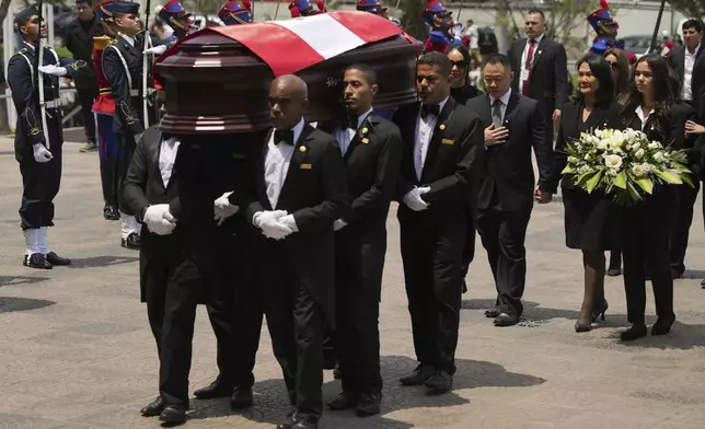 Keiko Fujimori and her brother Kenji follow pallbearers carrying the coffin of their father, former President Alberto Fujimori to a museum for his wake in Lima, Peru, Thursday, Sept. 12, 2024. (AP Photo/Guadalupe Pardo)