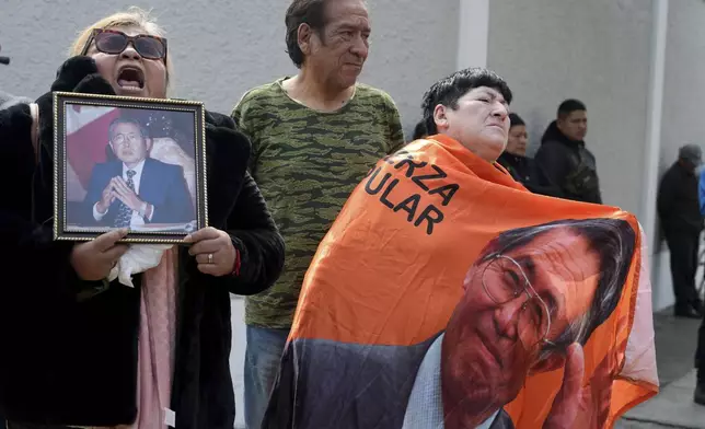 Supporters of former President Alberto Fujimori gather outside the home of his daughter Keiko, the day after he died in Lima, Peru, Thursday, Sept. 12, 2024. (AP Photo/Guadalupe Pardo)