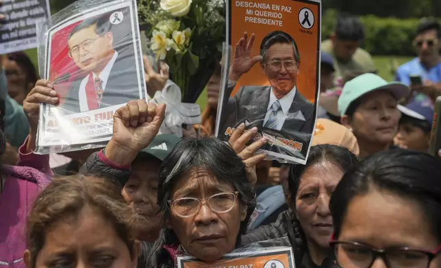 Supporters of former President Alberto Fujimori gather outside the cemetery during his funeral in Lima, Peru, Saturday, Sept. 14, 2024. (AP Photo/Guadalupe Pardo)