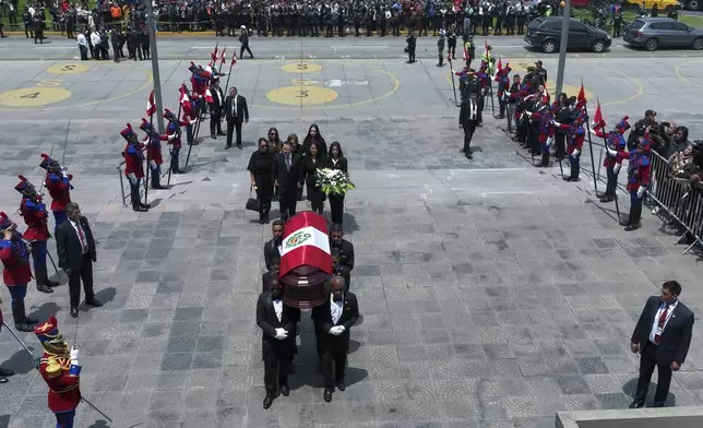 Keiko Fujimori, her brother Kenji, and other relatives follow pallbearers carrying the coffin of their father, former President Alberto Fujimori, to a museum for his wake in Lima, Peru, Thursday, Sept. 12, 2024. (AP Photo/Guadalupe Pardo)