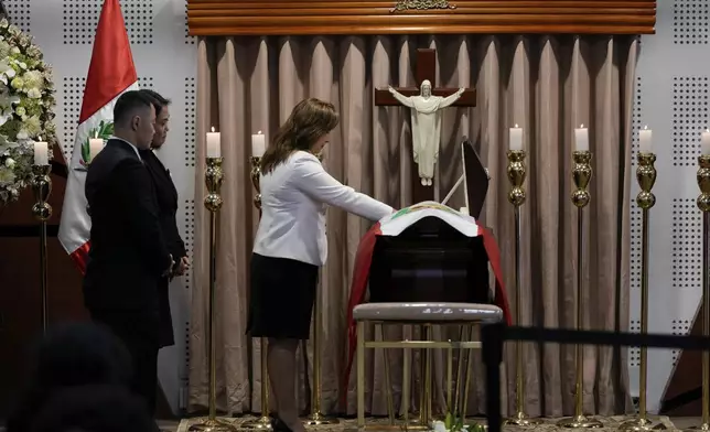 Kenji Fujimori and his sister Keiko look on as Peruvian President Dina Boluarte pays her respects to late former President Alberto Fujimori during his wake in Lima, Peru, Thursday, Sept. 12, 2024. (AP Photo/Guadalupe Pardo)