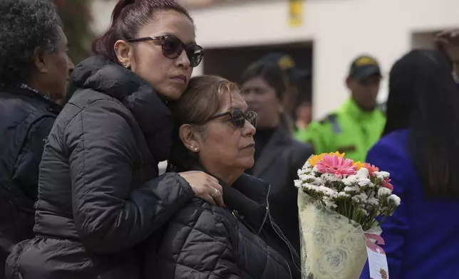 Supporters of former President Alberto Fujimori gather outside the home of his daughter Keiko, the day after he died in Lima, Peru, Thursday, Sept. 12, 2024. (AP Photo/Guadalupe Pardo)