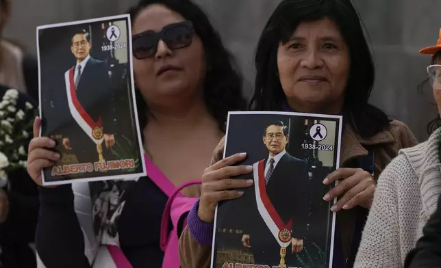 Supporters of former President Alberto Fujimori line up to pay their respects outside a museum where his body is lying in Lima, Peru, Thursday, Sept. 12, 2024. (AP Photo/Guadalupe Pardo)