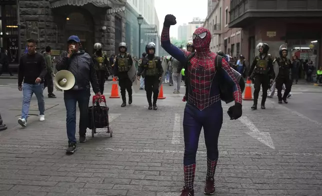 A demonstrator dressed in a Spiderman costume takes part in a march calling on the government to take stronger action to control fires in the country's Amazon region, in Lima, Peru, Wednesday, Sept. 18, 2024. (AP Photo/Guadalupe Pardo)