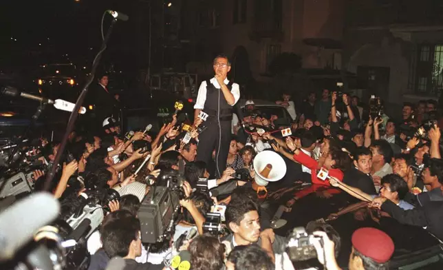 FILE - Peruvian President Alberto Fujimori gives a press conference in front of the Japanese ambassador's residence in Lima, Peru, April 22, 1997. His daughter Keiko Fujimori announced in a post on X that he died of cancer on Wednesday, September 11, 2024. (AP Photo/Eugene Hoshiko, File)