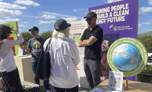 People look at exhibits at the Climate Science Fair, an outdoor exhibit hosted by the Emerson Collective during the annual Climate Week NYC and United Nations General Assembly on Sunday, Sept. 22, 2024, in New York. (AP Photo/Thalia Beaty)