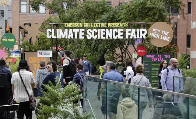 People arrive at the Climate Science Fair, an outdoor exhibit hosted by the Emerson Collective during the annual Climate Week NYC and United Nations General Assembly, on Monday, Sept. 23, 2024 in New York. (AP Photo/Peter Morgan)