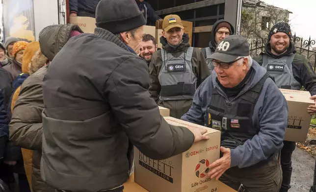 This undated photo provided by the Howard G. Buffett Foundation shows philanthropist Howard Buffett, son of Warren Buffett, distributing aid in Posad-Pokrovske, Ukraine. (Spencer Taylor/Howard G. Buffett Foundation via AP)