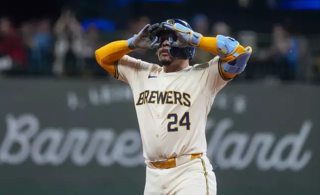 Milwaukee Brewers' William Contreras reacts after hitting a two-run scoring double during the third inning of a baseball game against the Philadelphia Phillies Monday, Sept. 16, 2024, in Milwaukee. (AP Photo/Morry Gash)