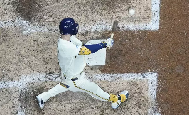 Milwaukee Brewers' Brice Turang hits an RBI single during the sixth inning of a baseball game against the Philadelphia Phillies Monday, Sept. 16, 2024, in Milwaukee. (AP Photo/Morry Gash)