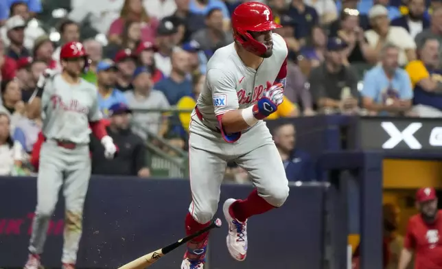 Philadelphia Phillies' Kyle Schwarber hits an RBI single during the seventh inning of a baseball game against the Milwaukee Brewers Tuesday, Sept. 17, 2024, in Milwaukee. (AP Photo/Morry Gash)