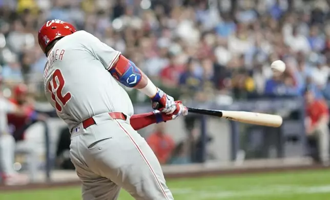 Philadelphia Phillies' Kyle Schwarber hits a single during the eighth inning of a baseball game against the Milwaukee Brewers Wednesday, Sept. 18, 2024, in Milwaukee. (AP Photo/Morry Gash)