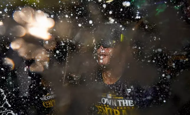 Milwaukee Brewers' Freddy Peralta is douced after a baseball game against the Philadelphia Phillies Wednesday, Sept. 18, 2024, in Milwaukee. The Brewers won 2-1 and clinched the National League Central division. (AP Photo/Morry Gash)