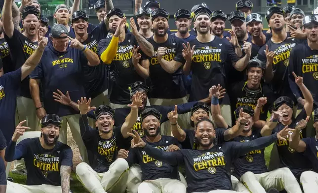 The Milwaukee Brewers celebrate after a baseball game against the Philadelphia Phillies Wednesday, Sept. 18, 2024, in Milwaukee. The Brewers won 2-1 and clinched the National League Central division. (AP Photo/Morry Gash)