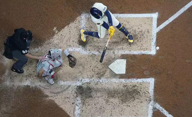 Milwaukee Brewers' Rhys Hoskins hits a home run during the fifth inning of a baseball game against the Philadelphia Phillies Wednesday, Sept. 18, 2024, in Milwaukee. (AP Photo/Morry Gash)