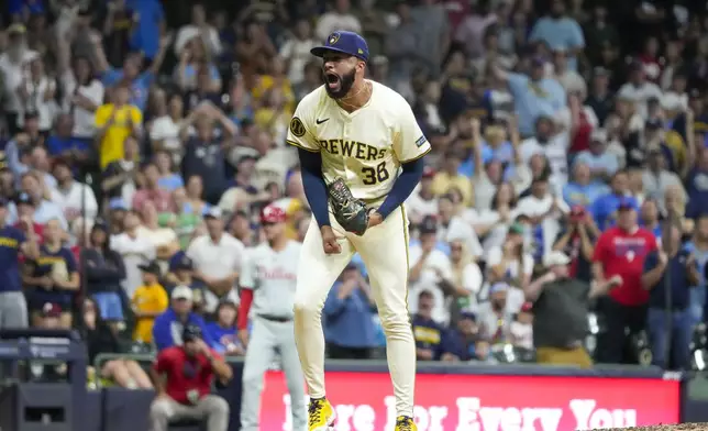 Milwaukee Brewers pitcher Devin Williams reacts after striking out Philadelphia Phillies' Brandon Marsh during the ninth inning of a baseball game Wednesday, Sept. 18, 2024, in Milwaukee. (AP Photo/Morry Gash)