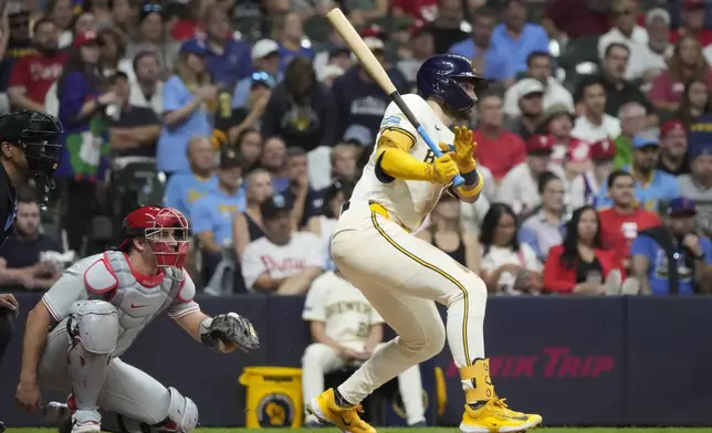 Milwaukee Brewers' Garrett Mitchell hits an RBI triple during the fourth inning of a baseball game against the Philadelphia Phillies Tuesday, Sept. 17, 2024, in Milwaukee. (AP Photo/Morry Gash)