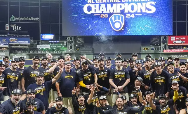 The Milwaukee Brewers celebrate after a baseball game against the Philadelphia Phillies Wednesday, Sept. 18, 2024, in Milwaukee. The Brewers won 2-1 and clinched the National League Central division. (AP Photo/Morry Gash)