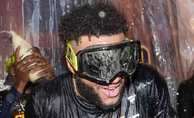 Milwaukee Brewers' Jackson Chourio is douced after a baseball game against the Philadelphia Phillies Wednesday, Sept. 18, 2024, in Milwaukee. The Brewers won 2-1 and clinched the National League Central division. (AP Photo/Morry Gash)