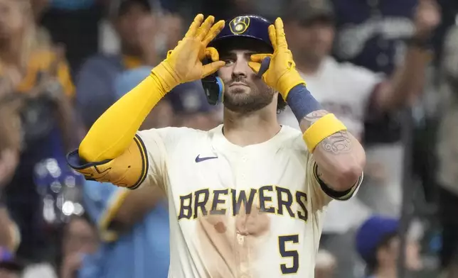 Milwaukee Brewers' Garrett Mitchell reacts after hitting an RBI triple during the fourth inning of a baseball game against the Philadelphia Phillies Tuesday, Sept. 17, 2024, in Milwaukee. (AP Photo/Morry Gash)