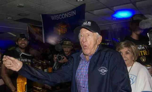 The Milwaukee Brewers annopuncer Bob Uecker celebrates after a baseball game against the Philadelphia Phillies Wednesday, Sept. 18, 2024, in Milwaukee. The Brewers won 2-1 and clinched the National League Central division. (AP Photo/Morry Gash)