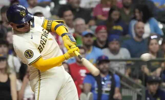 Milwaukee Brewers' William Contreras hits a single during the fourth inning of a baseball game against the Philadelphia Phillies Tuesday, Sept. 17, 2024, in Milwaukee. (AP Photo/Morry Gash)