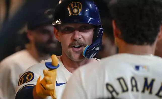 Milwaukee Brewers' Rhys Hoskins is congratulated after hitting a home run during the fifth inning of a baseball game against the Philadelphia Phillies Wednesday, Sept. 18, 2024, in Milwaukee. (AP Photo/Morry Gash)