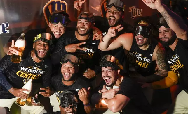 The Milwaukee Brewers celebrate after a baseball game against the Philadelphia Phillies Wednesday, Sept. 18, 2024, in Milwaukee. The Brewers won 2-1 and clinched the National League Central division. (AP Photo/Morry Gash)