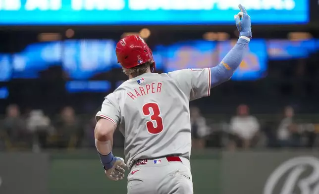 Philadelphia Phillies' Bryce Harper reacts after hitting a two-run homr run during the sixth inning of a baseball game against the Milwaukee Brewers Tuesday, Sept. 17, 2024, in Milwaukee. (AP Photo/Morry Gash)