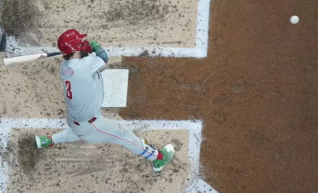 Philadelphia Phillies' Bryce Harper hits a single during the fourth inning of a baseball game against the Milwaukee Brewers Monday, Sept. 16, 2024, in Milwaukee. (AP Photo/Morry Gash)