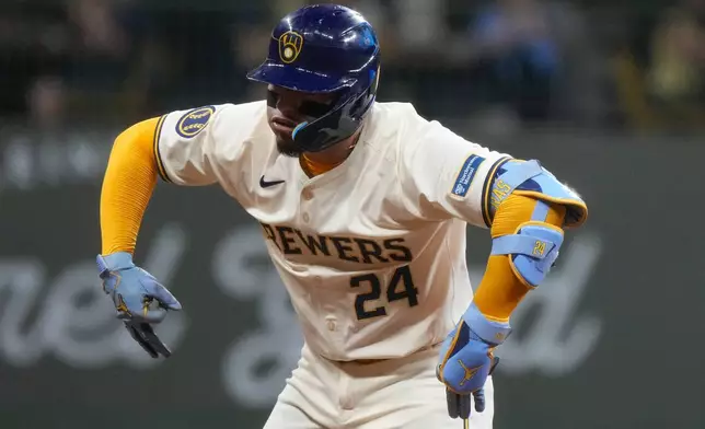 Milwaukee Brewers' William Contreras reacts after hitting a two-run scoring double during the third inning of a baseball game against the Philadelphia Phillies Monday, Sept. 16, 2024, in Milwaukee. (AP Photo/Morry Gash)