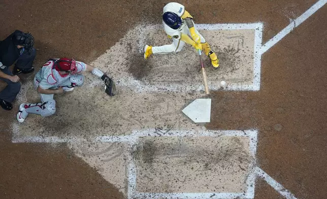 Milwaukee Brewers' Joey Ortiz hits an RBI triple during the sixth inning of a baseball game against the Philadelphia Phillies Monday, Sept. 16, 2024, in Milwaukee. (AP Photo/Morry Gash)