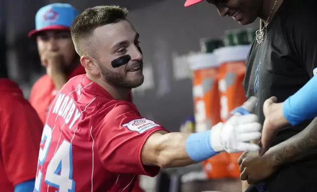 Miami Marlins' Connor Norby is congratulated by his teammates after hitting a two-run home run during the first inning of a baseball game against the Philadelphia Phillies, Saturday, Sept. 7, 2024, in Miami. (AP Photo/Marta Lavandier)