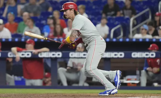 Philadelphia Phillies' Bryson Stott (5) hits a single during the first inning of a baseball game against the Miami Marlins, Saturday, Sept. 7, 2024, in Miami. (AP Photo/Marta Lavandier)