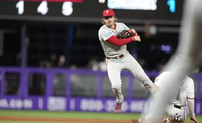 Philadelphia Phillies second baseman Bryson Stott throws to first where Miami Marlins' Otto Lopez was safe during the fourth inning of a baseball game, Thursday, Sept. 5, 2024, in Miami. (AP Photo/Lynne Sladky)