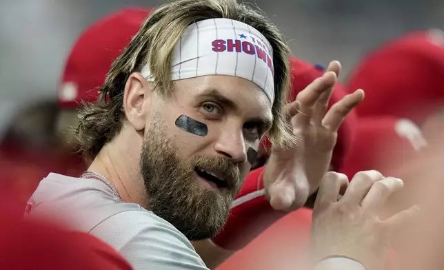 Philadelphia Phillies' Bryce Harper reacts in the dugout during the fourth inning of a baseball game against the Miami Marlins, Thursday, Sept. 5, 2024, in Miami. (AP Photo/Lynne Sladky)