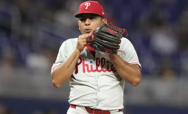 Philadelphia Phillies starting pitcher Ranger Suarez blows on his glove hand during the third inning of a baseball game against the Miami Marlins, Thursday, Sept. 5, 2024, in Miami. (AP Photo/Lynne Sladky)