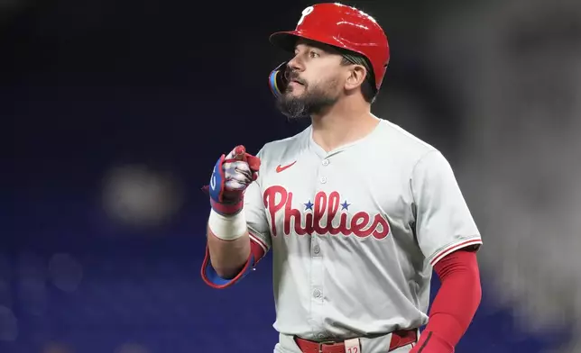 Philadelphia Phillies' Kyle Schwarber reacts after reaching first on a throwing error by Miami Marlins first baseman Jake Burger during the first inning of a baseball game, Friday, Sept. 6, 2024, in Miami. (AP Photo/Lynne Sladky)