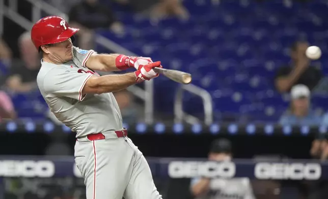 Philadelphia Phillies' J.T. Realmuto hits a single during the fourth inning of a baseball game against the Miami Marlins, Thursday, Sept. 5, 2024, in Miami. (AP Photo/Lynne Sladky)