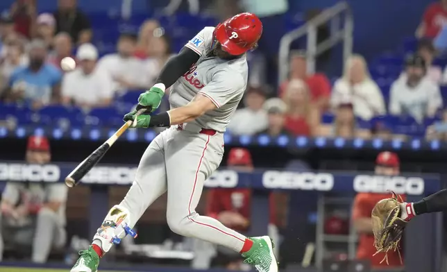 Philadelphia Phillies' Bryce Harper flies out during the first inning of a baseball game against the Miami Marlins, Sunday, Sept. 8, 2024, in Miami. (AP Photo/Lynne Sladky)