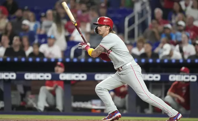 Philadelphia Phillies' Bryson Stott follows through on an RBI single to score Trea Turner during the first inning of a baseball game against the Miami Marlins, Thursday, Sept. 5, 2024, in Miami. (AP Photo/Lynne Sladky)