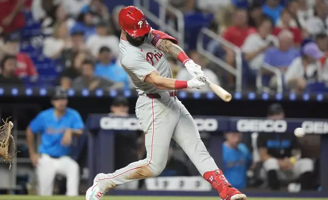 Philadelphia Phillies' Weston Wilson bats to reach on a fielding error by Miami Marlins third baseman Connor Norby during the sixth inning of a baseball game, Sunday, Sept. 8, 2024, in Miami. (AP Photo/Lynne Sladky)