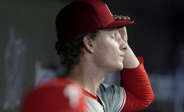 Philadelphia Phillies starting pitcher Seth Johnson stands in the dugout after being relieved during the third inning of a baseball game against the Miami Marlins, Sunday, Sept. 8, 2024, in Miami. (AP Photo/Lynne Sladky)